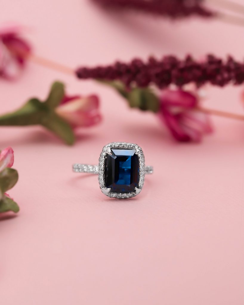 Gemstone Jewelry in Dallas - Diamond and Gold Warehouse. Emerald Cut Blue Sapphire Ring with Diamond Halo
